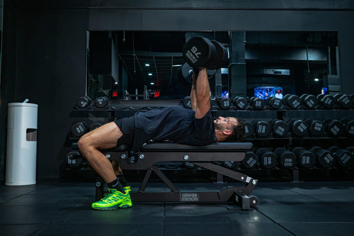 Athlete performing a dumbbell bench press at GYM NYC Lexington