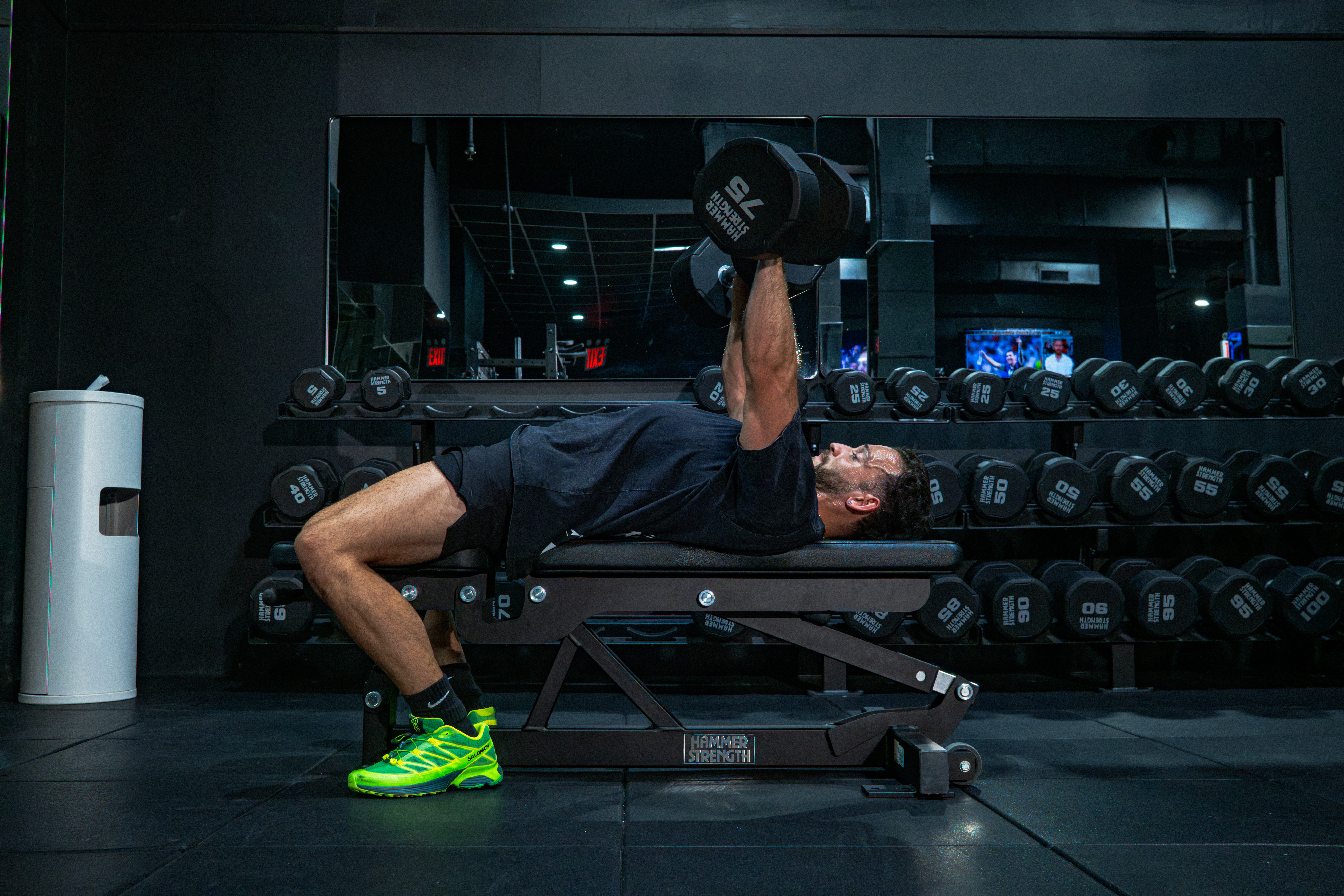 Athlete performing a dumbbell bench press at GYM NYC Lexington